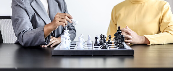 Two business women competitors playing chess board game, business competition concept, business plan to be the number one company, competitor analysis and problem solving. For always good results.