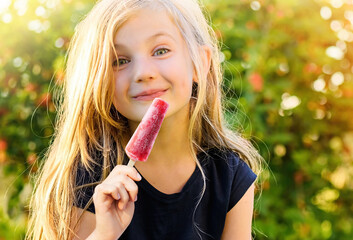 Cute and happy little girl with frozen popsicle