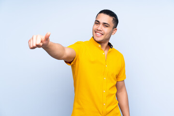 Asian handsome man over isolated background giving a thumbs up gesture