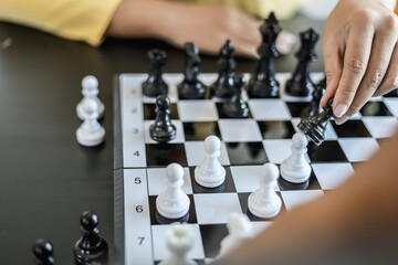 Two business women competitors playing chess board game, business competition concept, business...