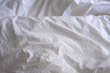 White linens. Bed. Bed linen texture.