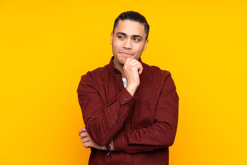 Asian handsome man isolated on yellow background with headache