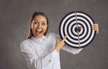 Wow, right in bullseye. Studio portrait of excited smiling lady looking at camera pointing finger...
