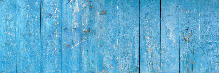 Wooden background. Old blue shabby wood planks. A tattered dilapidated fence. Natural creative texture for editing and design.