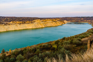 Lake with sandy bank in the abandoned coal quarry