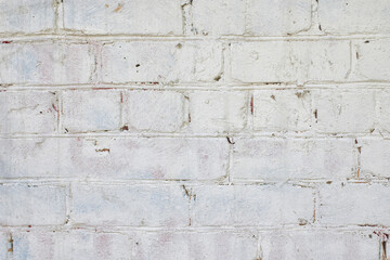 A fragment of a white brick wall. The texture of the stone.