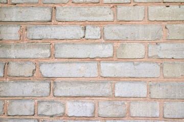 A fragment of a white brick wall. The texture of the stone.