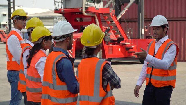 manager training group of asian foreman and worker in morning meeting  before entering start working in industrial loading container box at warehouse logistic cargo import export shipping business