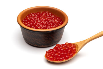 Red caviar in a bowl and a spoon isolated on white background