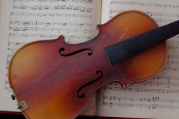 vintage brown violin music instrument on white sheet music