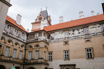 Fototapeta na wymiar Gothic Castle Brandys nad Labem, Renaissance palace, clock tower, Historical Courtyard with sgraffito mural decorated plaster at facade, wall decor, Central Bohemian, Czech Republic