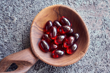 Krill oil pills on a spoon. Healthy food supplement.