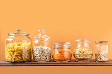 Different legumes in glass jars: chickpeas, pasta, beans, peas, lentils. Zero waste storage, plastic free.