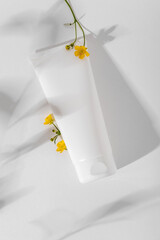 White cosmetic mockup on white background. Concept of minimalism in cosmetic packaging.