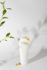 White cosmetic mockup on white background. Concept of minimalism in cosmetic packaging. White cosmetic tube for face cream.