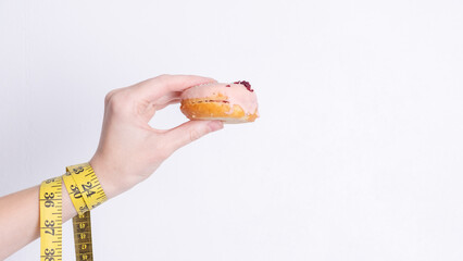 Tempting donuts dessert with iceing and sprinkles. Sweet sugar round doughnuts of different flavours. Top horizontal view copyspace. Healthy diet and junk food concept