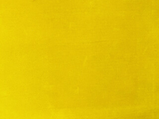 Yellow velvet fabric texture used as background. Empty yellow fabric background of soft and smooth textile material. There is space for text.