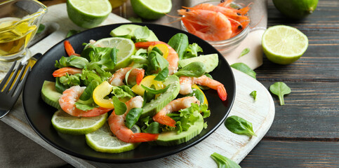 Concept of tasty eating with shrimp salad on wooden table