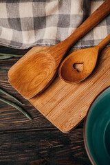 kitchen utensils lie on a wooden background, top view