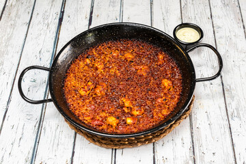Paella de arroz a banda with pieces of squid and marine flavors