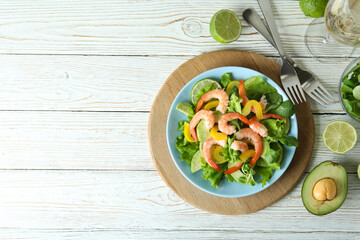Concept of tasty eating with shrimp salad on wooden table