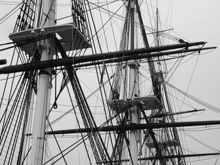 Monochromatic image of a bunch of tall masts.