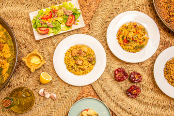 Dishes of Spanish paellas and paella dishes on natural fiber trivets