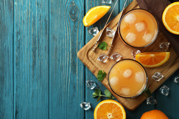 Tequila Sunrise cocktails and ingredients on wooden table