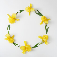 Invitation with a border and a wreath with an ornament of iris flowers of yellow bright color. Minimal decorative banner idea.