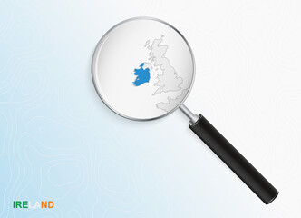 Magnifier with map of Ireland on abstract topographic background.
