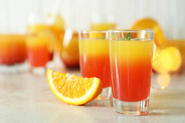 Tequila sunrise cocktails on white textured table, close up
