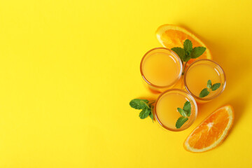 Tequila sunrise cocktails and ingredients on yellow background