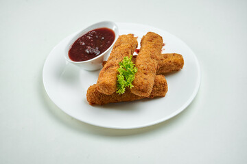 Appetizing beer snack - mozzarella fries cheese sticks with cranberry sauce in a white plate on a white background