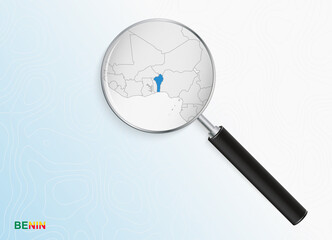 Magnifier with map of Benin on abstract topographic background.