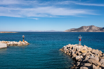 Stone breakwater with a lighthouse aerial drone view.Koufonisia Cyclades islands, Greece - obrazy, fototapety, plakaty