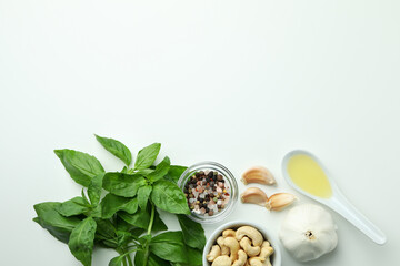 Pesto sauce and ingredients on white background