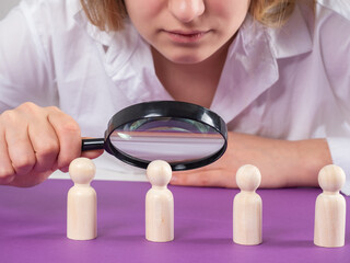 Manager hand with magnifying glass. Concept of employee monitoring by boss. Search employee for...