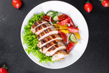 salad grilled chicken breast vegetables tomato, cucumber, onion mix poultry meat organic dish on the table healthy food meal snack copy space food background rustic. top view keto or paleo diet