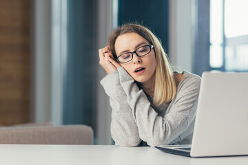 exhausted woman at work yawns from painful sensations caused by wrong posture, sedentary work, long...