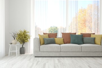 Stylish room in white color with sofa and autumn landscape in window. Scandinavian interior design. 3D illustration