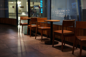 Wooden chairs and tables as part of the interior in a cafe             
