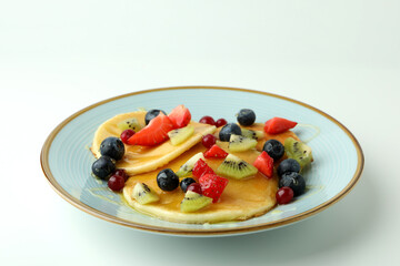 Concept of delicious dessert with pancakes on white background