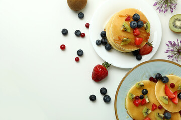 Concept of delicious dessert with pancakes on white background