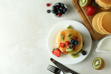 Concept of delicious dessert with pancakes on white textured table