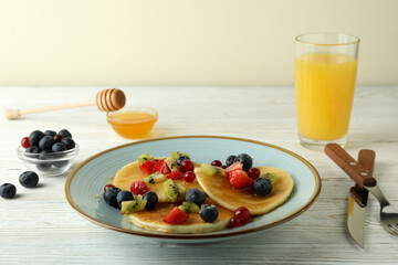 Concept of delicious dessert with pancakes on white wooden table