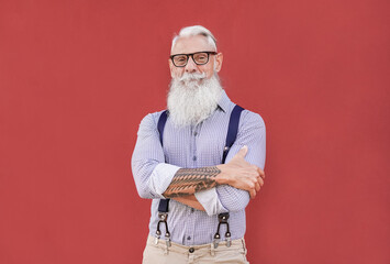Happy hipster senior man looking in camera and smiling - Trendy elderly person with grey hair and...