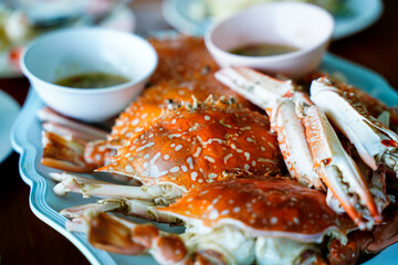 Close up stream crabs or Portunus armatus in serving bowl with seafood sauce side dish in...
