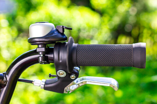 Bicycle hand brake. Bicycle handle. Bike bell. Bicycle wheel. - Powered by Adobe