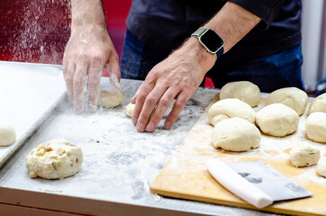 Obraz na płótnie Canvas Chief baker prepares bun dough