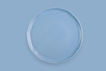 blue plain plate for non-circular lunch, dinner or dinner on blue background